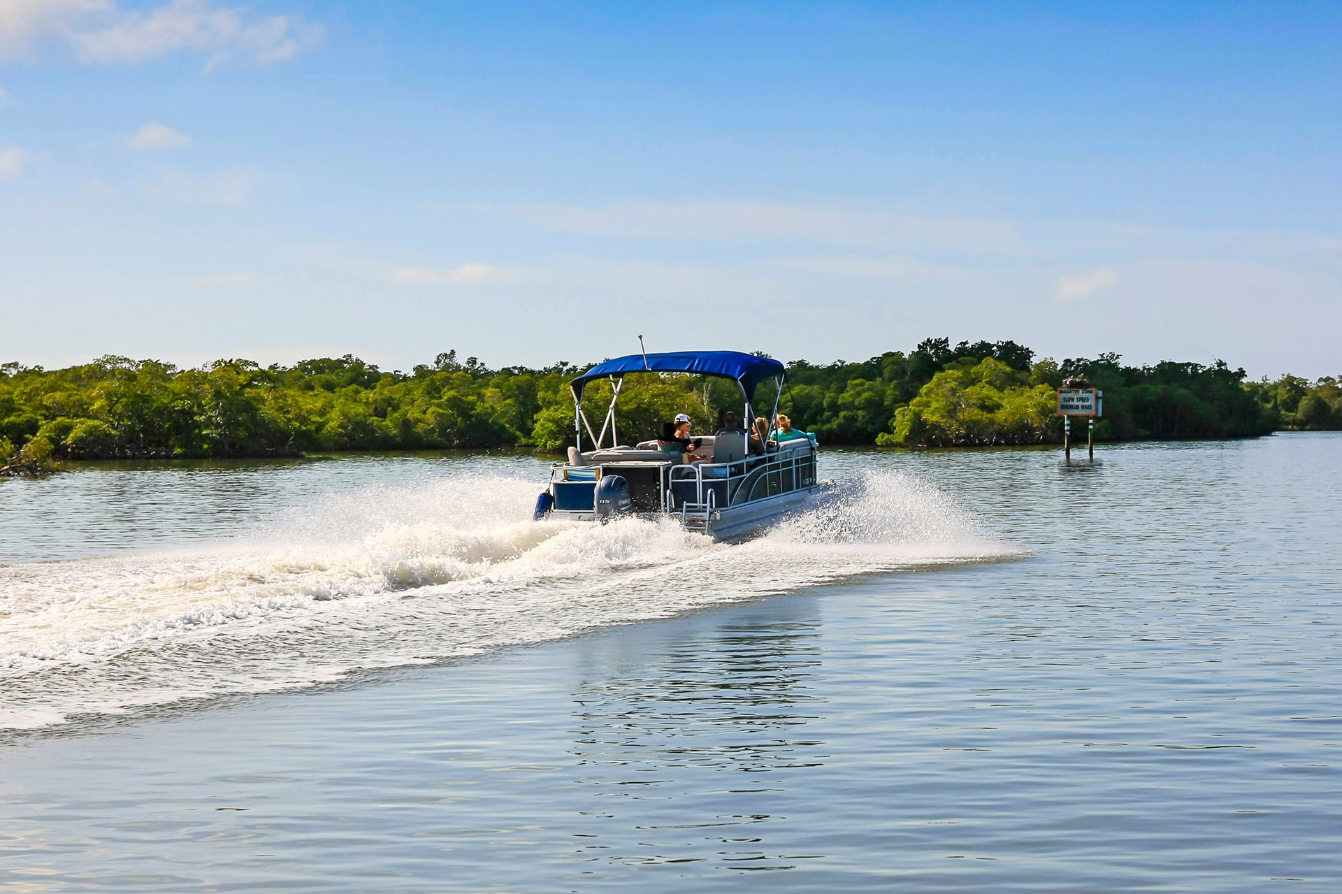 Family enjoying a day out on a pontoon boat on the lake